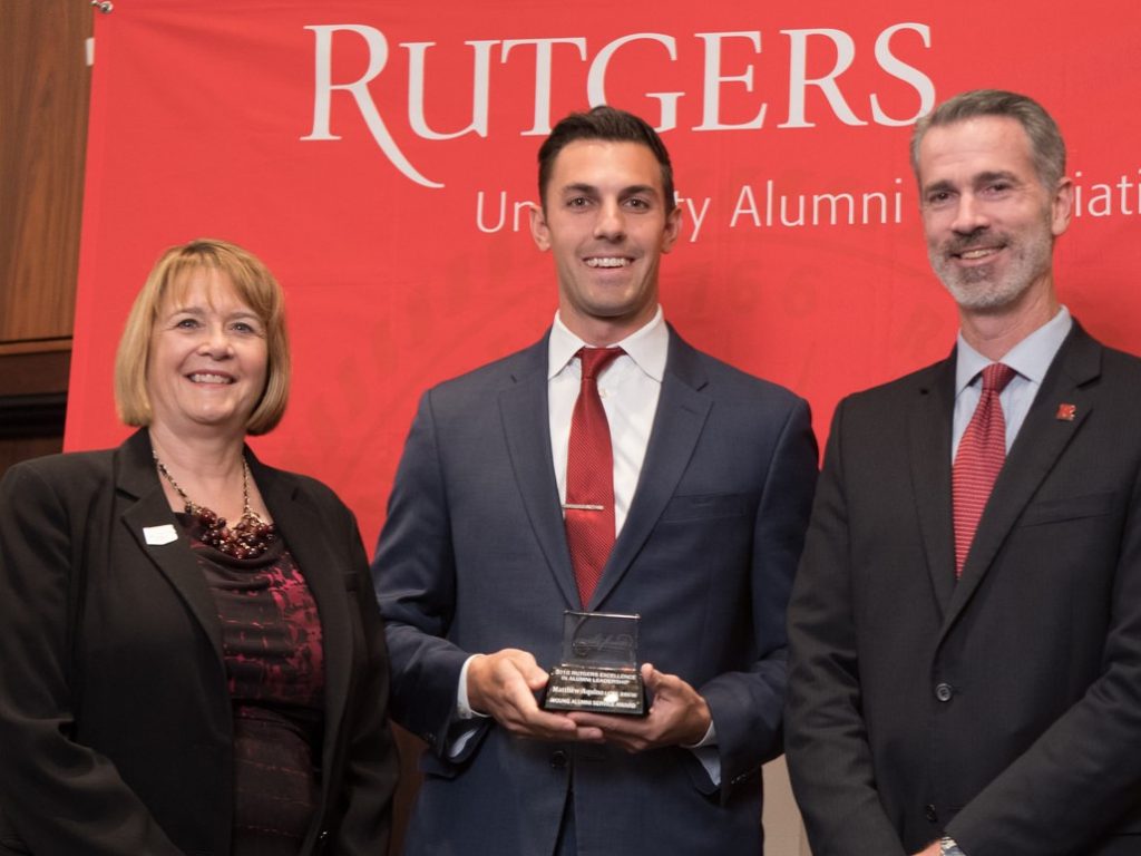 Matthew Aquino, center, accepts the Rutgers University Alumni Association's (RUAA) Young Alumni Service Award from Donna K. Thornton, Rutgers’ Vice President for Alumni Relations, and Timothy S. Farrow, Chairman of the RUAA Board.